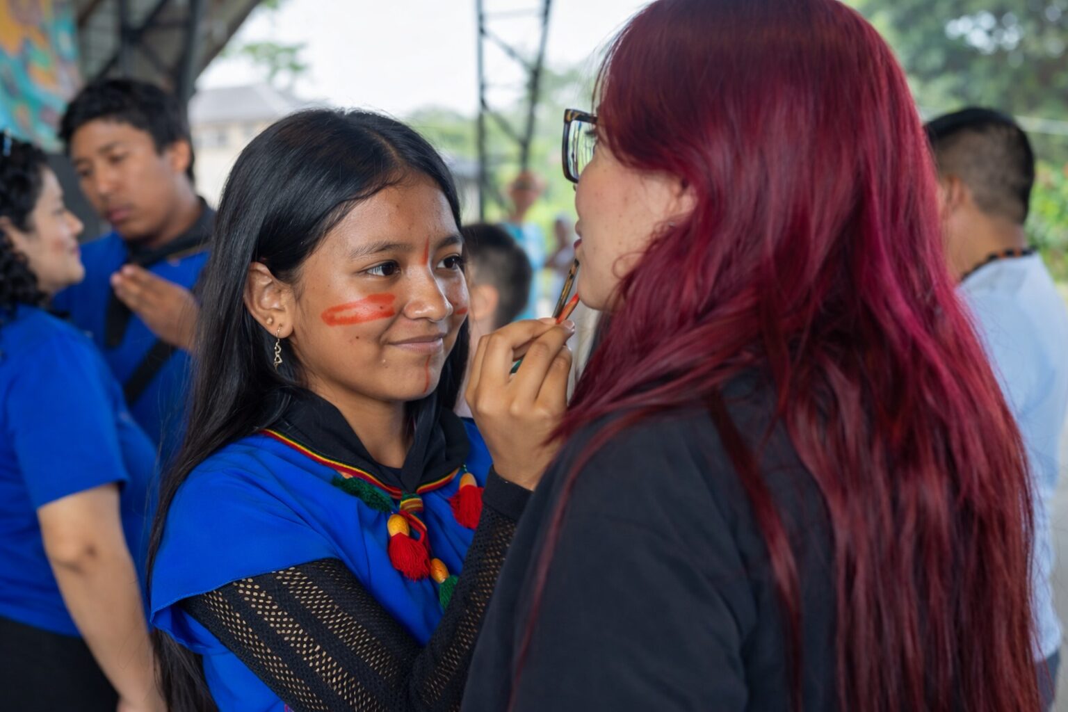 Melany Guaramag pinta el rostro de una maestra invitada a la toma de posesión del Semillero de Guardia, en octubre de 2025. Foto cortesía Morelia Mendúa  Alianza Ceib